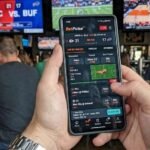A modern smartphone showcasing live sports betting app layouts reflecting current iGaming industry trends